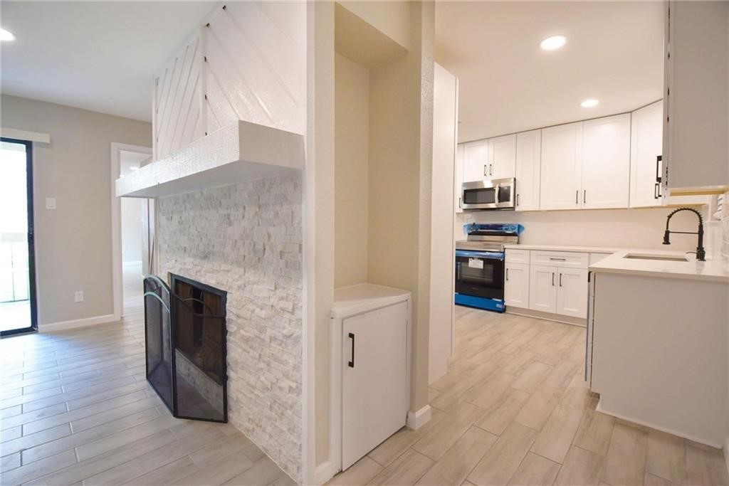 8600 Fathom Circle, Unit 1408 Austin, TX 78750 - Photo 3 of 17 a kitchen with stainless steel appliances granite countertop a refrigerator a stove and a sink