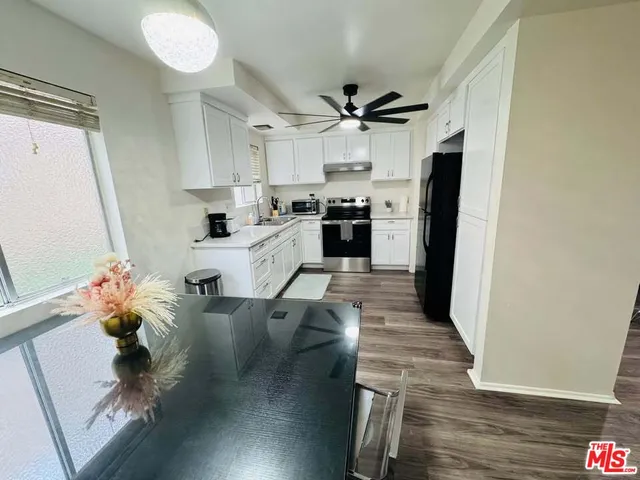 a kitchen with a sink appliances and cabinets