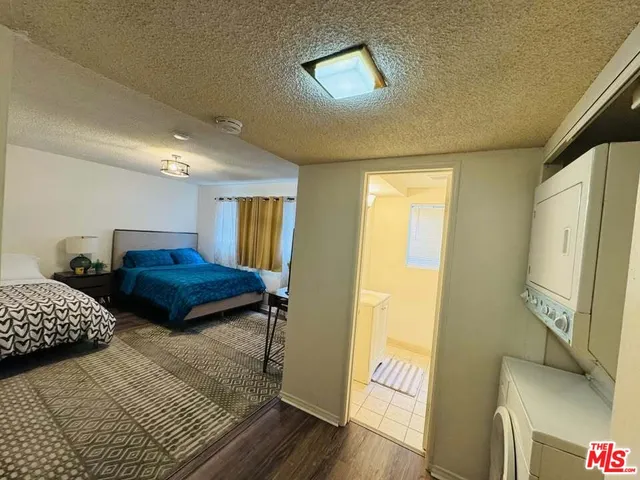 a view of bedroom with furniture and wooden floor