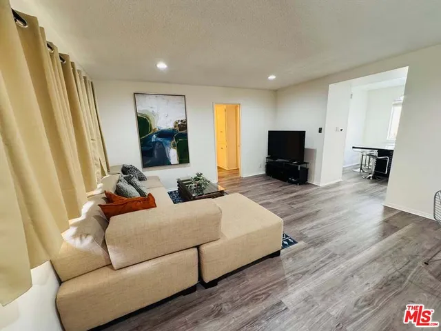a bedroom with a bed and a flat screen television