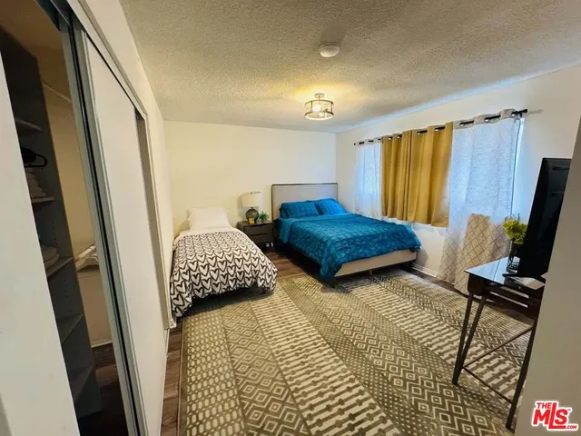 a bedroom with two beds and a window