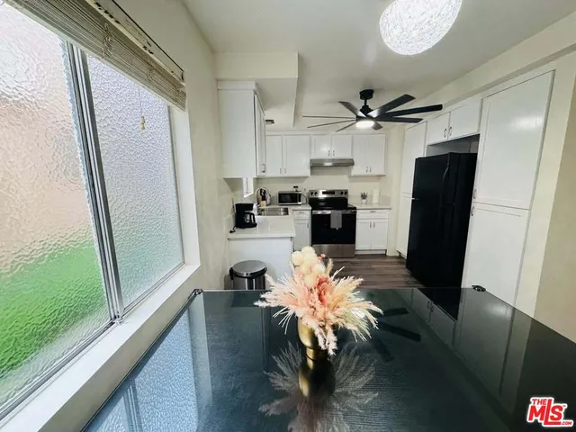 a kitchen with stainless steel appliances a refrigerator and a stove