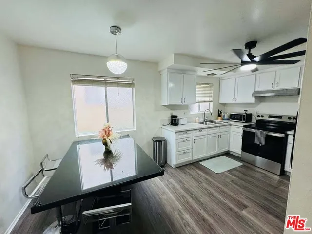 a kitchen with a sink appliances and cabinets