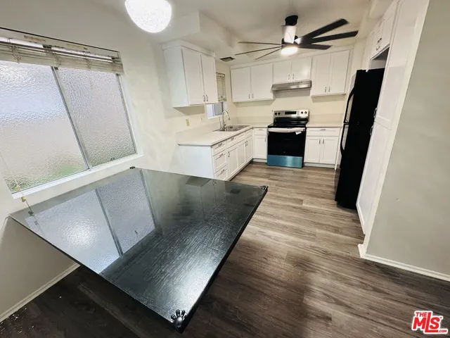a kitchen with white cabinets and white appliances