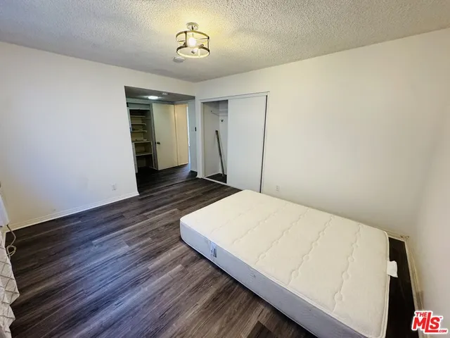 a view of a room with wooden floor and hallway