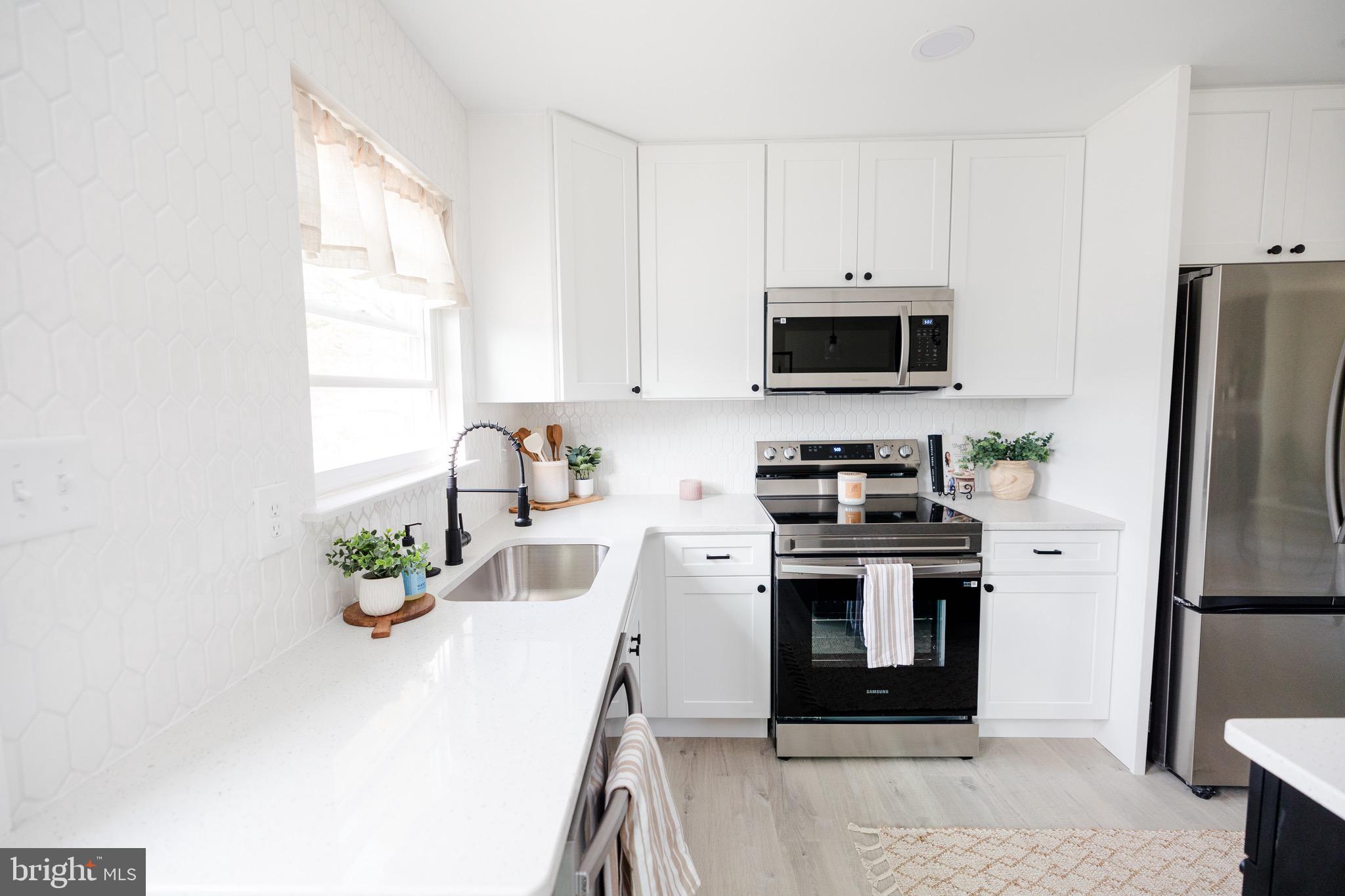 6 Valley Bend Road Westminster, MD 21157 - Photo 17 of 41 a kitchen with stainless steel appliances a stove a microwave and a refrigerator