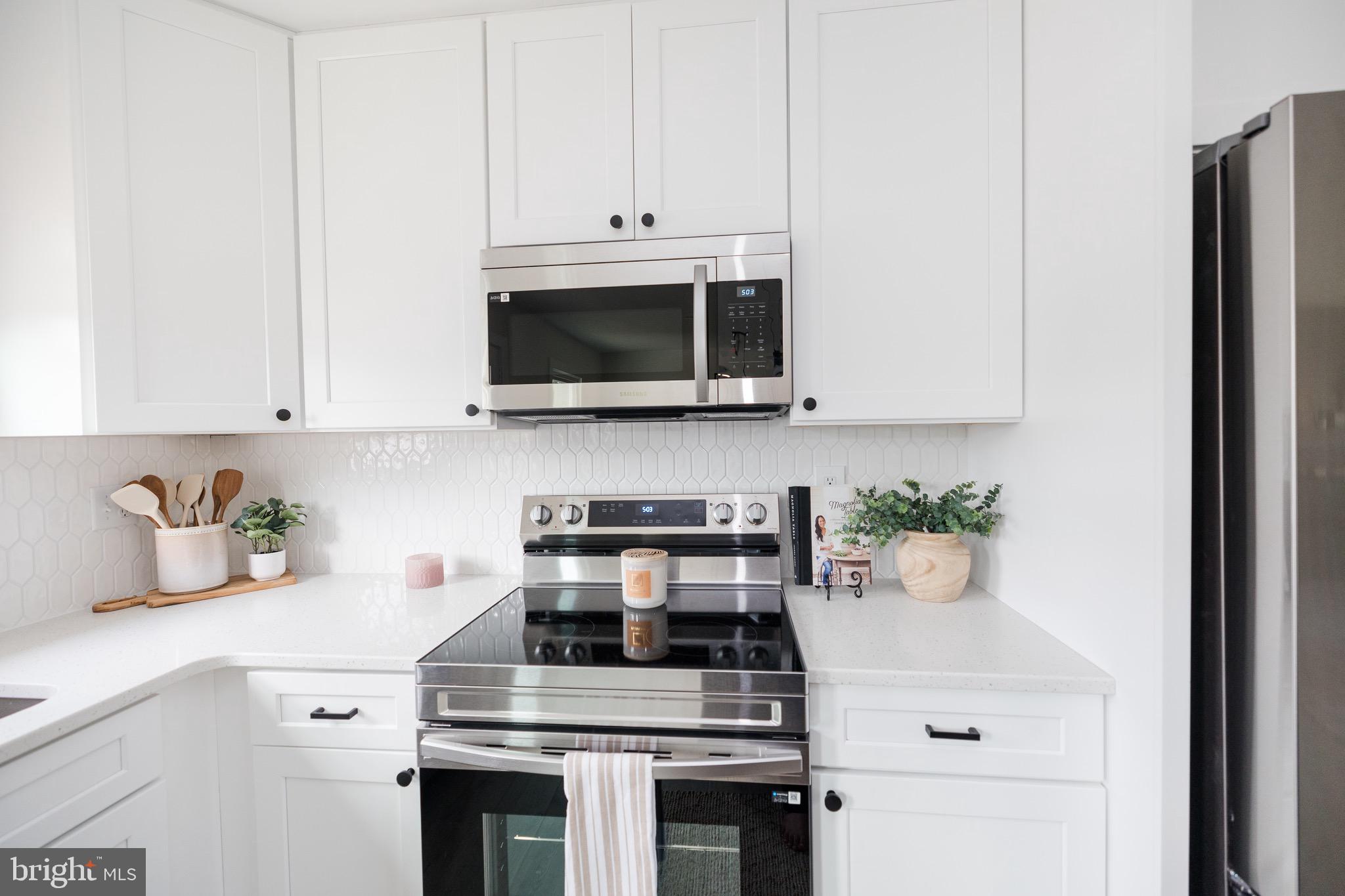 6 Valley Bend Road Westminster, MD 21157 - Photo 19 of 41 a kitchen with a stove and a microwave