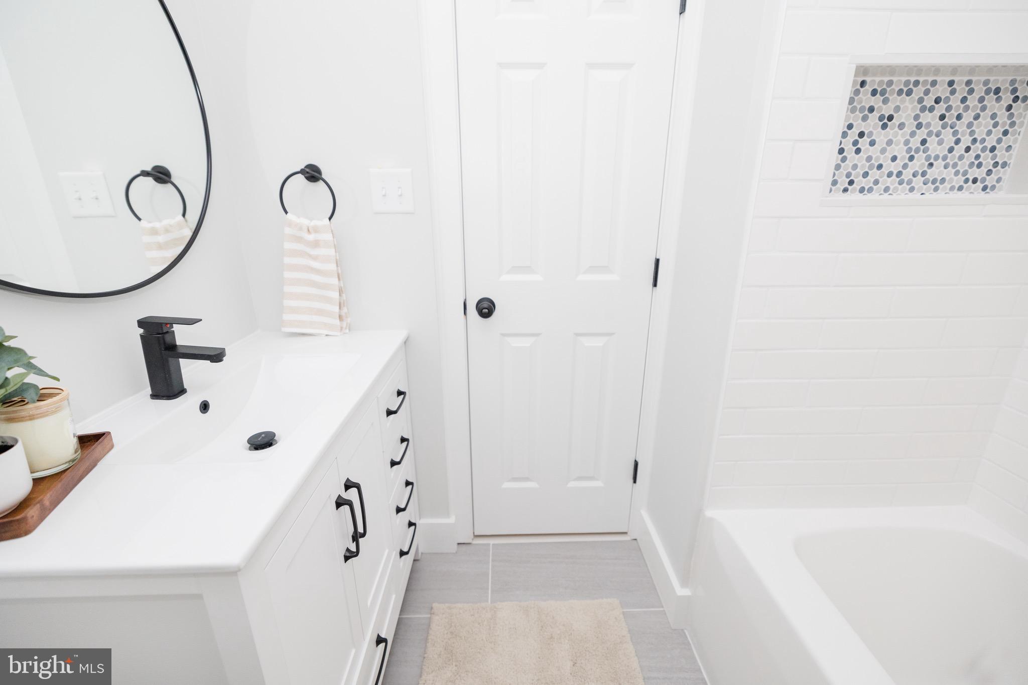 6 Valley Bend Road Westminster, MD 21157 - Photo 28 of 41 a bathroom with a sink a mirror and a bathtub
