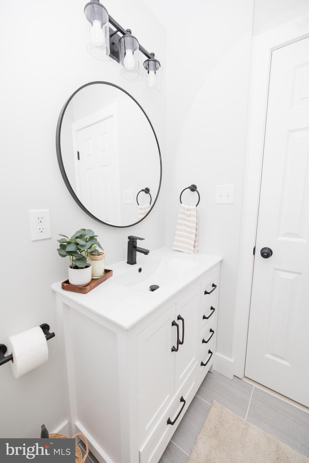 6 Valley Bend Road Westminster, MD 21157 - Photo 31 of 41 a bathroom with a sink mirror and vanity