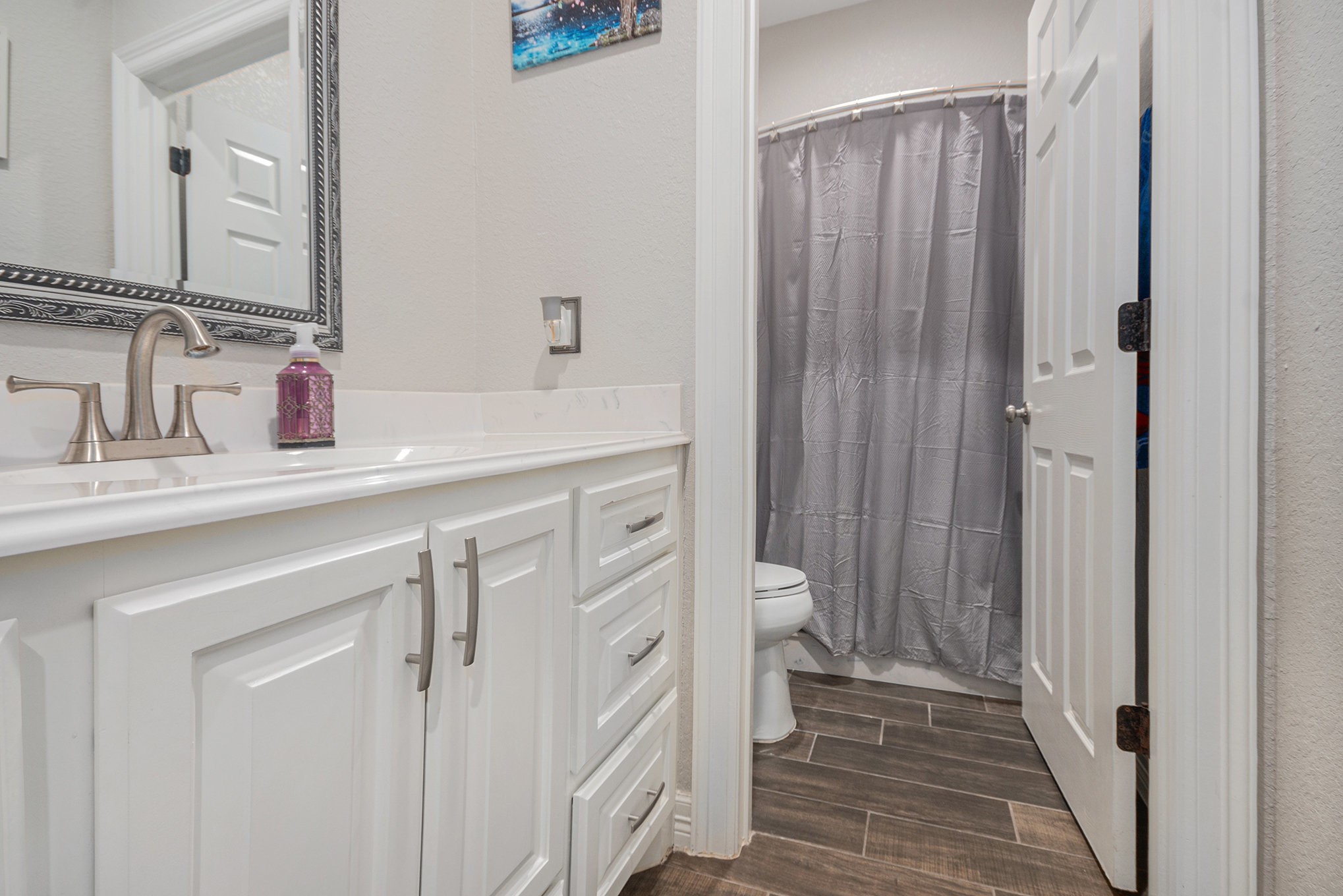 489 Sunset Trail Angleton, TX 77515 - Photo 18 of 39 a bathroom with a sink and a mirror