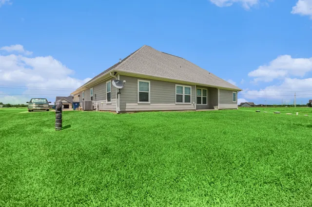 a view of a house with a yard and sitting area