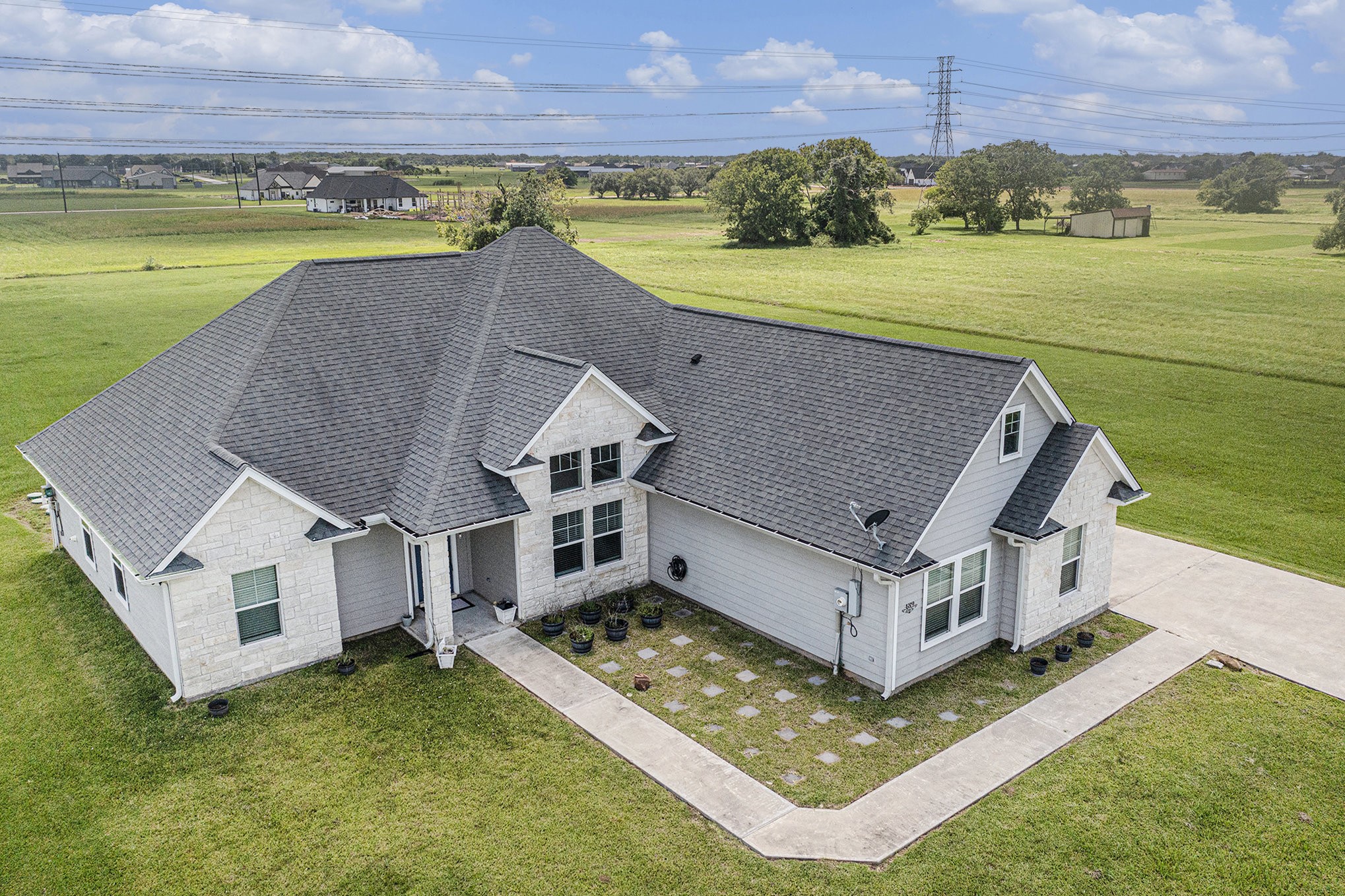 489 Sunset Trail Angleton, TX 77515 - Photo 25 of 39 an aerial view of a house with a garden and lake view