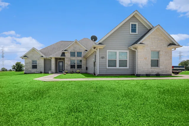 a front view of a house with a yard and porch