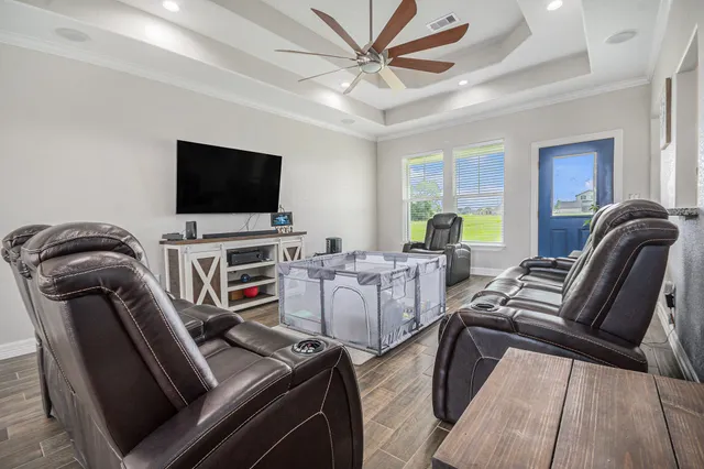 a view of a livingroom with furniture and a flat screen tv