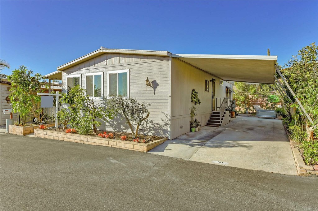 151 Falls View Lane Oceanside, CA 92056 - Photo 33 of 34 Carport large enough for 3 cars plus charging station for an electric car.