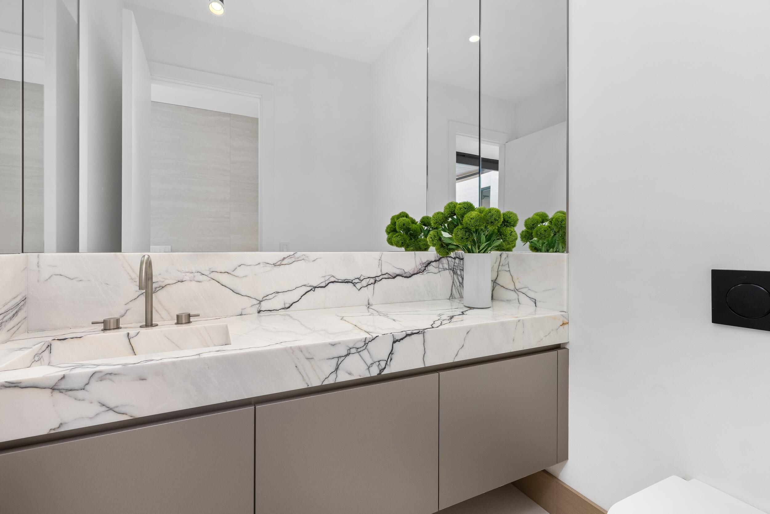 1351 Cocoanut Road Boca Raton, FL 33432 - Photo 27 of 101 a bathroom with a sink and a mirror
