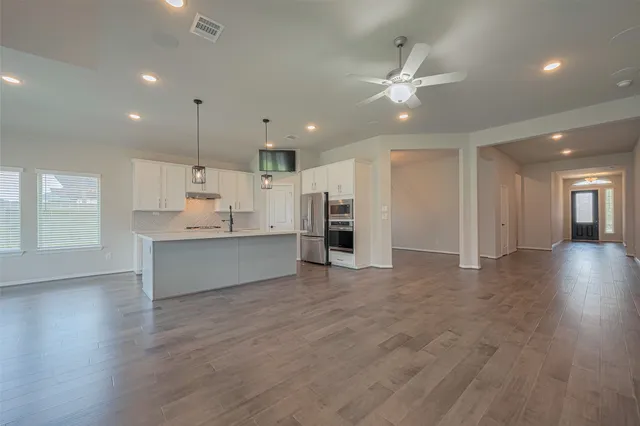a view of kitchen with center island and stainless steel appliances
