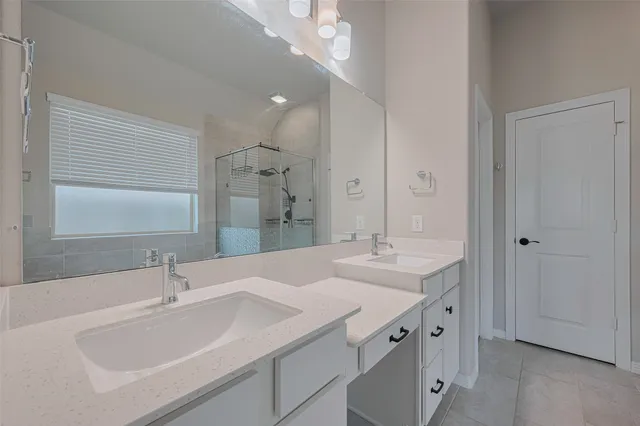 a bathroom with a sink double vanity and a mirror