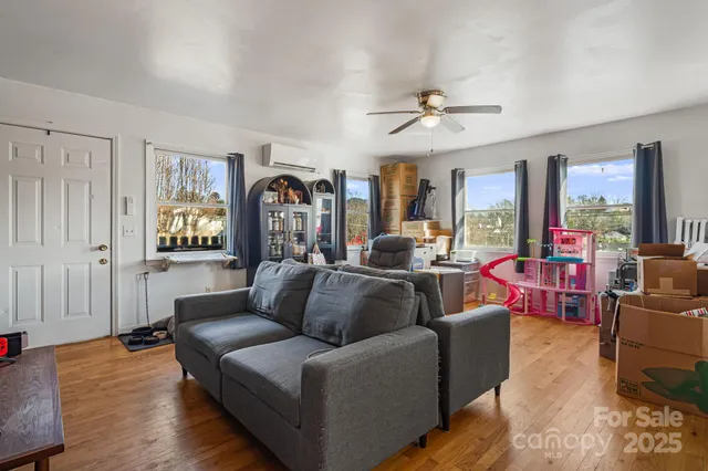 a living room with furniture and a chandelier