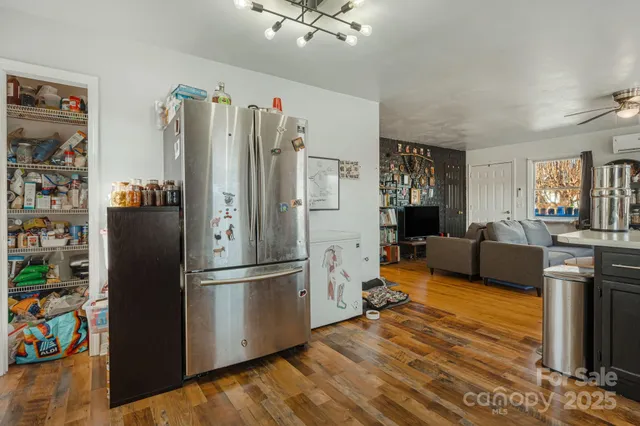 a kitchen with stainless steel appliances granite countertop a refrigerator and a stove top oven