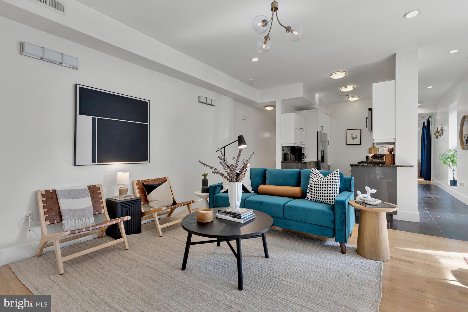 801 Q Street Northwest, Unit 1 Washington, DC 20001 - Photo 13 of 39 a living room with furniture a rug and a chandelier