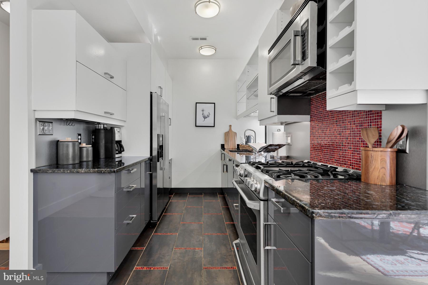 801 Q Street Northwest, Unit 1 Washington, DC 20001 - Photo 18 of 39 a kitchen with stainless steel appliances granite countertop a stove sink and cabinets