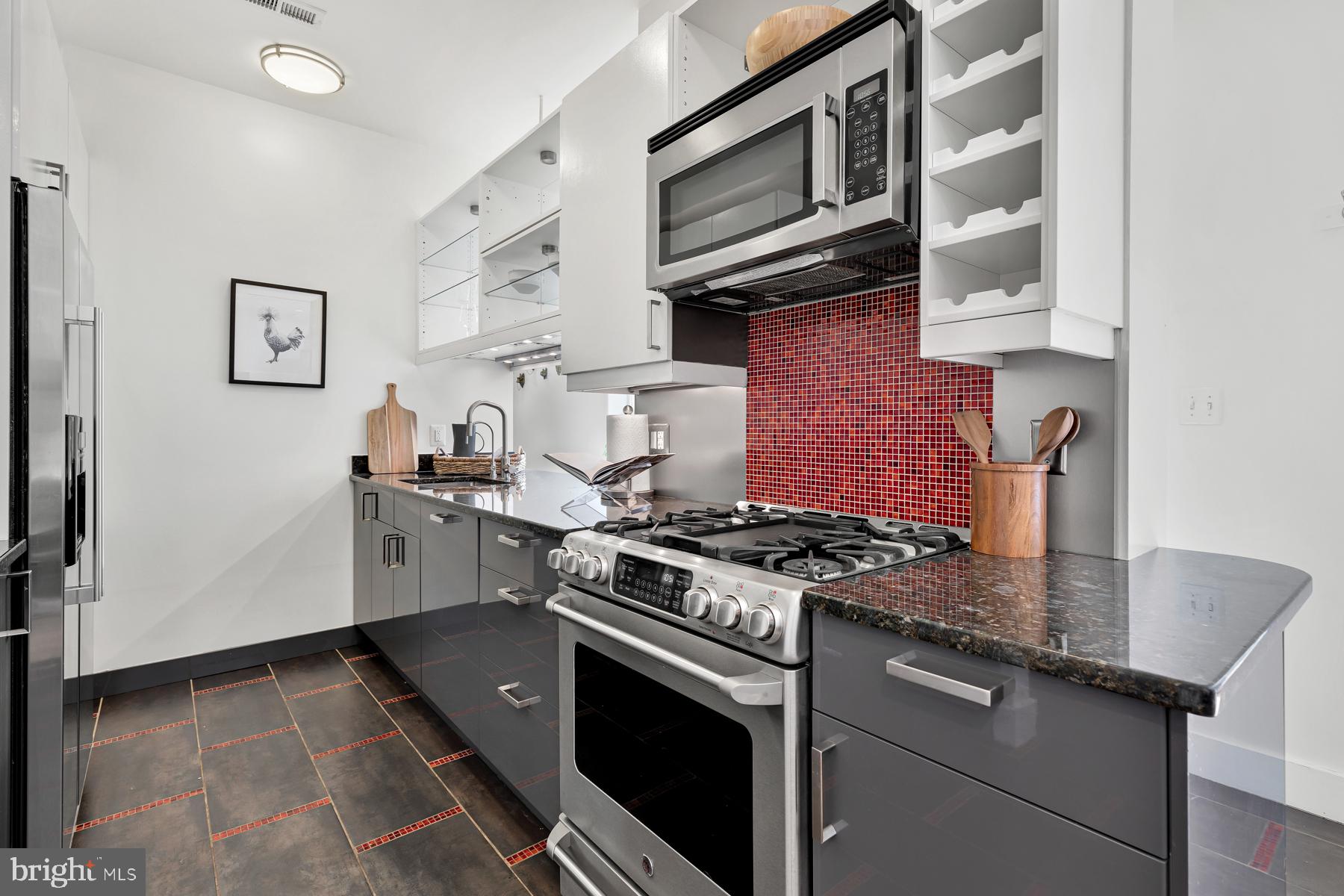 801 Q Street Northwest, Unit 1 Washington, DC 20001 - Photo 19 of 39 a kitchen with stainless steel appliances granite countertop a stove and a microwave