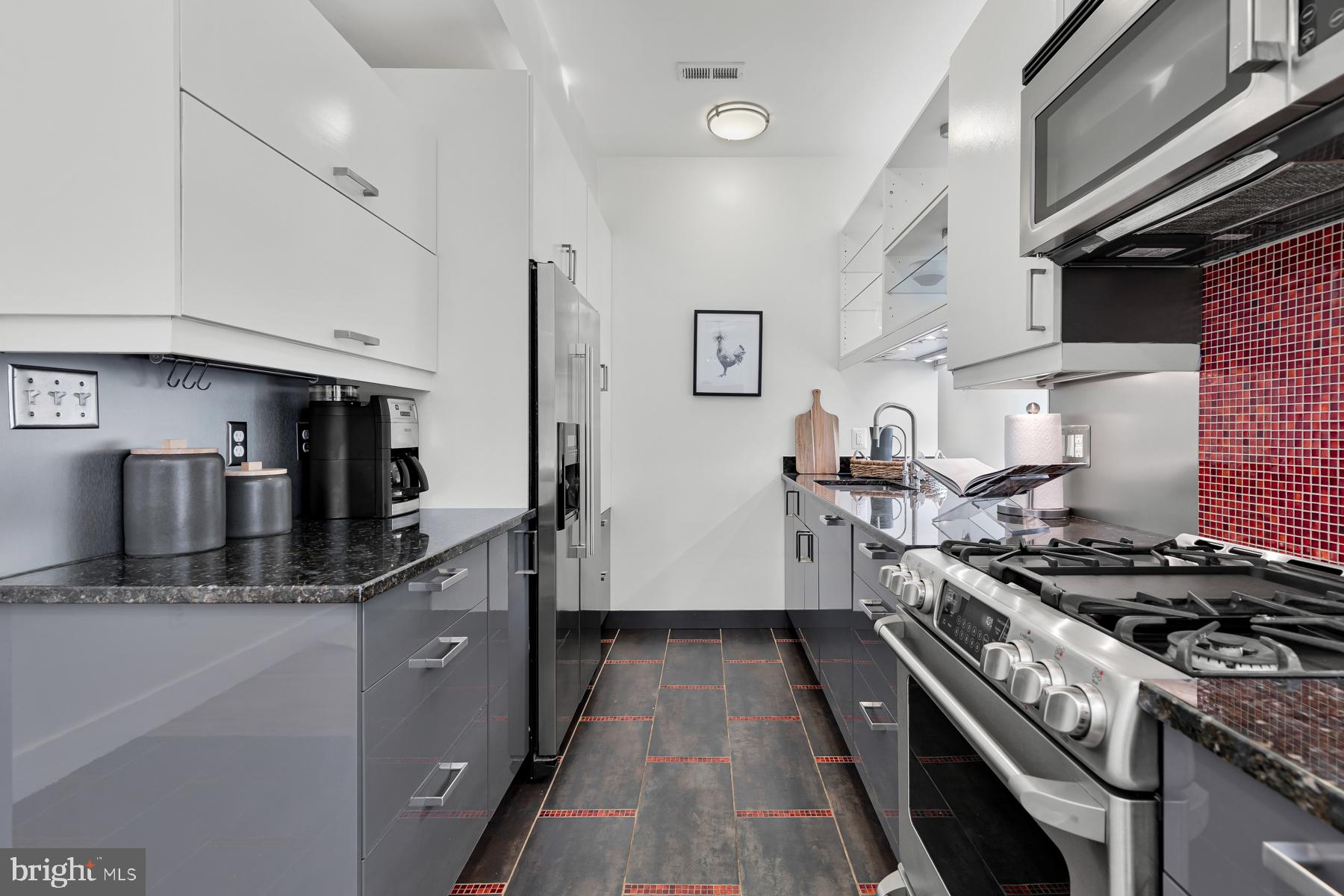 801 Q Street Northwest, Unit 1 Washington, DC 20001 - Photo 20 of 39 a kitchen with stainless steel appliances granite countertop a stove and a sink