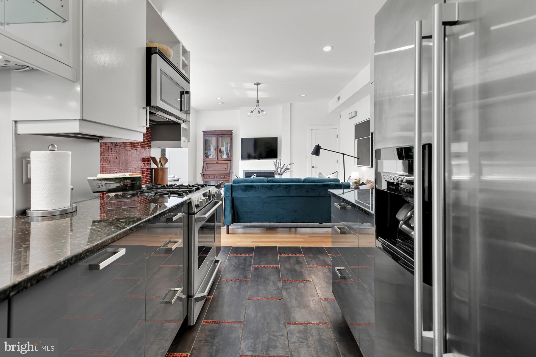 801 Q Street Northwest, Unit 1 Washington, DC 20001 - Photo 22 of 39 a kitchen with stainless steel appliances granite countertop a refrigerator a stove and a sink
