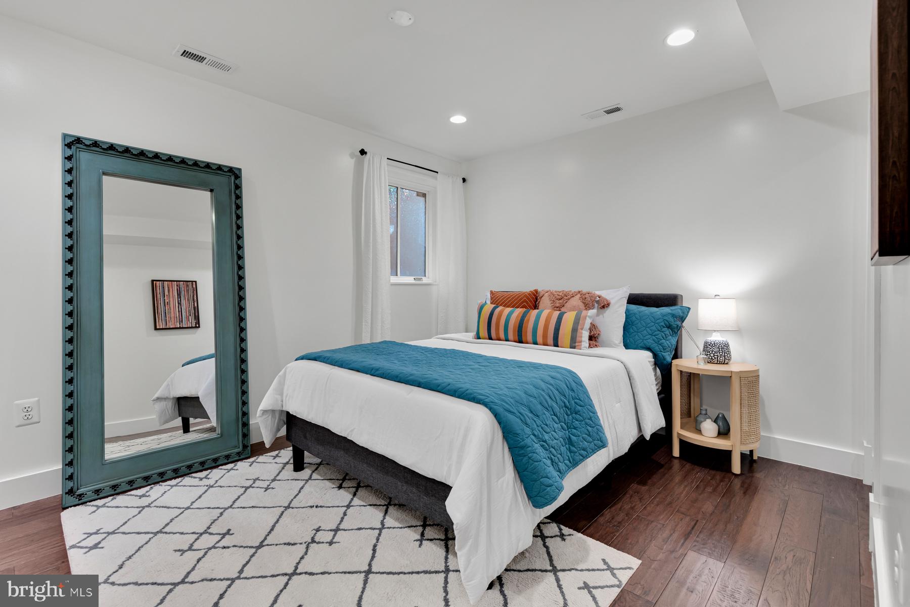 801 Q Street Northwest, Unit 1 Washington, DC 20001 - Photo 24 of 39 a bedroom with a bed and a night stand