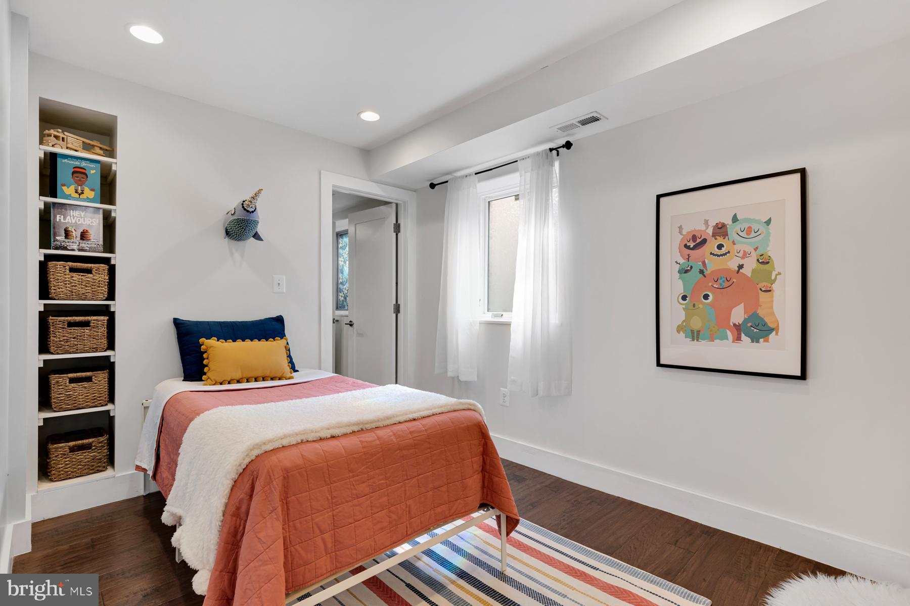 801 Q Street Northwest, Unit 1 Washington, DC 20001 - Photo 28 of 39 a bedroom with a bed and a painting on the wall