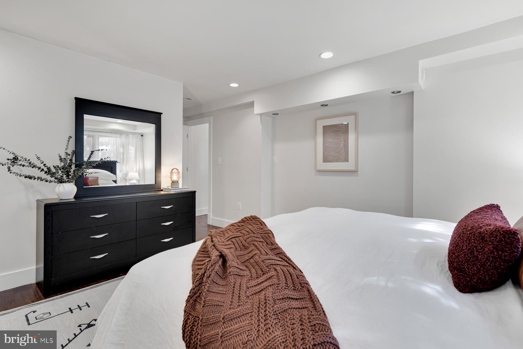 801 Q Street Northwest, Unit 1 Washington, DC 20001 - Photo 34 of 39 a bedroom with a bed and a dresser