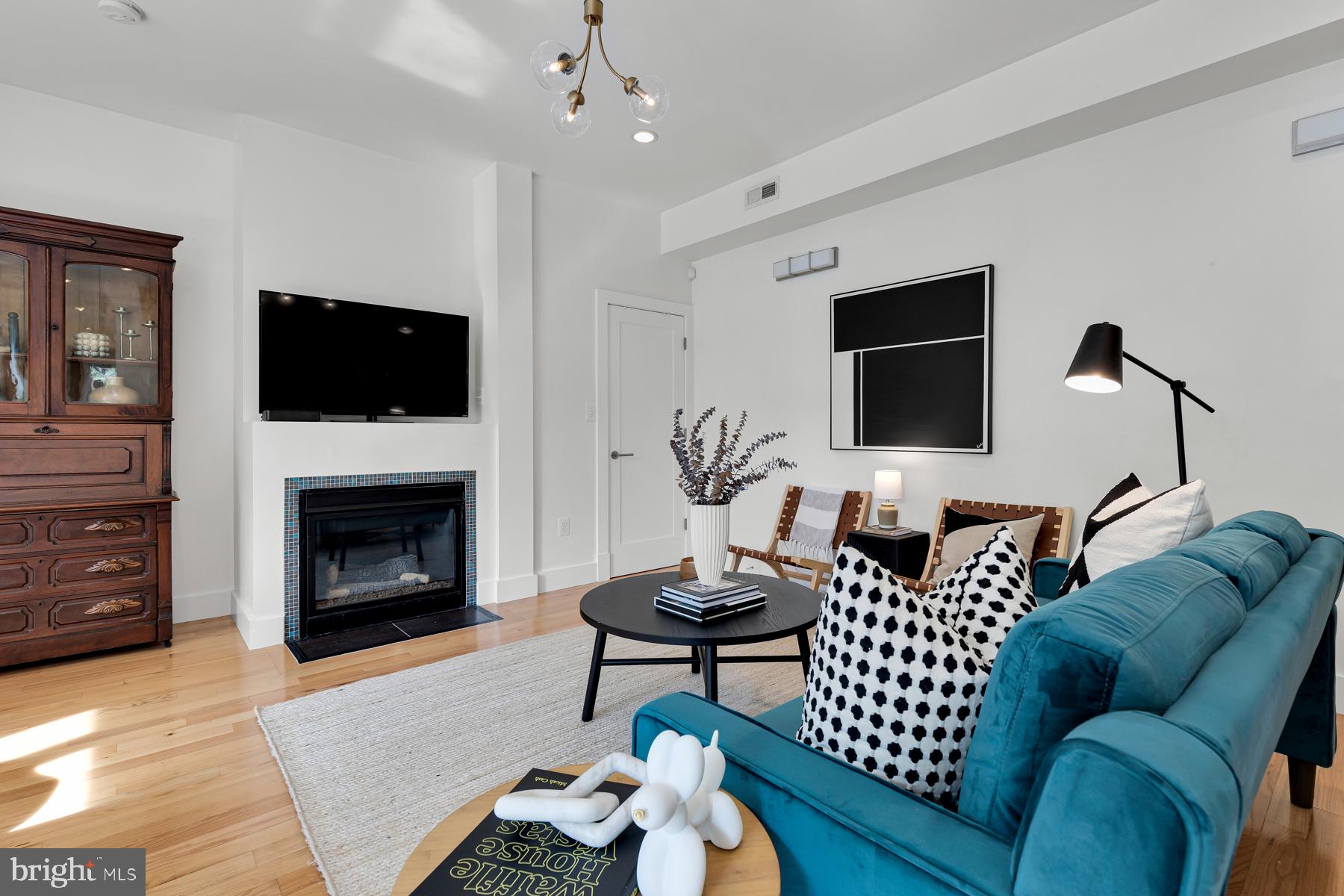 801 Q Street Northwest, Unit 1 Washington, DC 20001 - Photo 8 of 39 a living room with furniture a flat screen tv and a fireplace