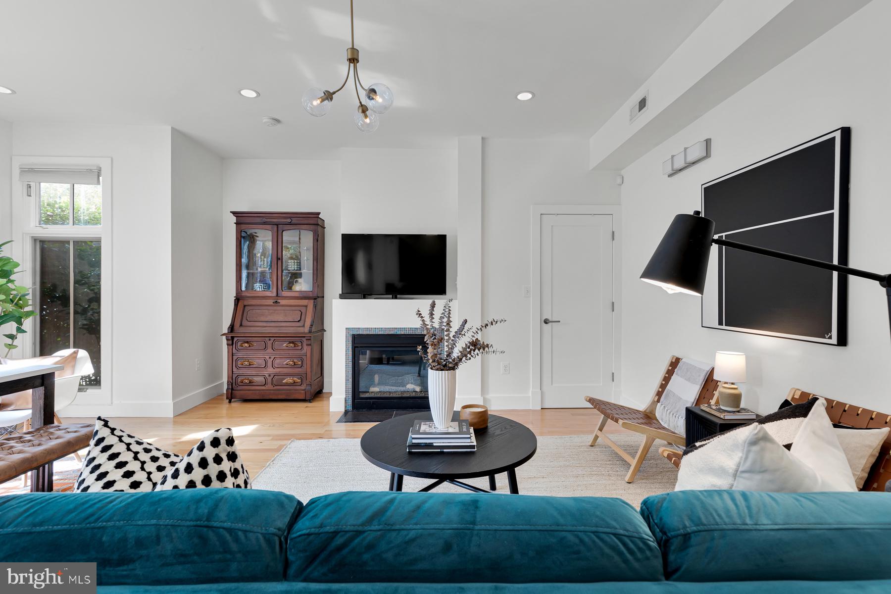 801 Q Street Northwest, Unit 1 Washington, DC 20001 - Photo 9 of 39 a living room with furniture and a flat screen tv