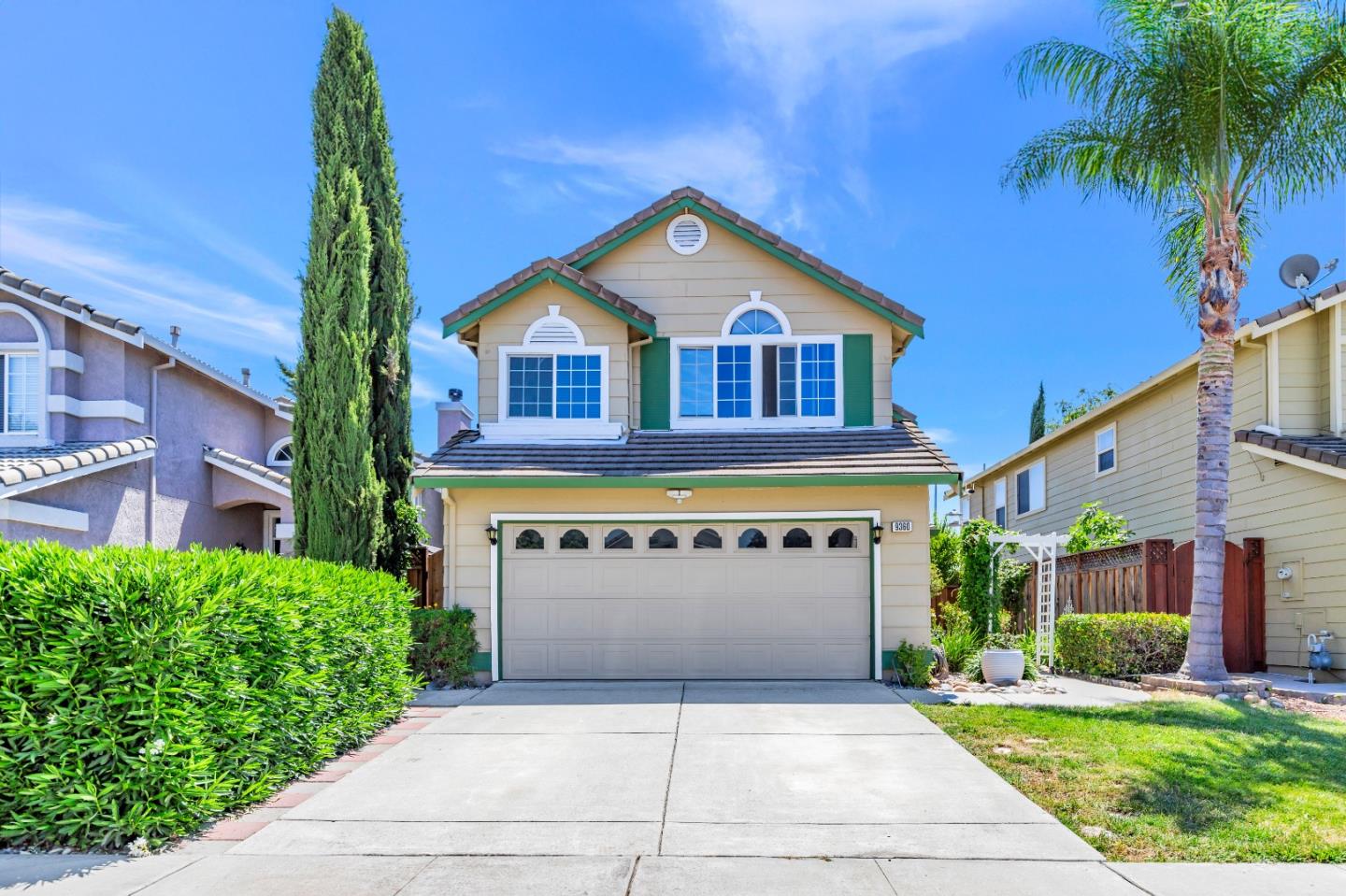 a front view of a house with a yard and garage