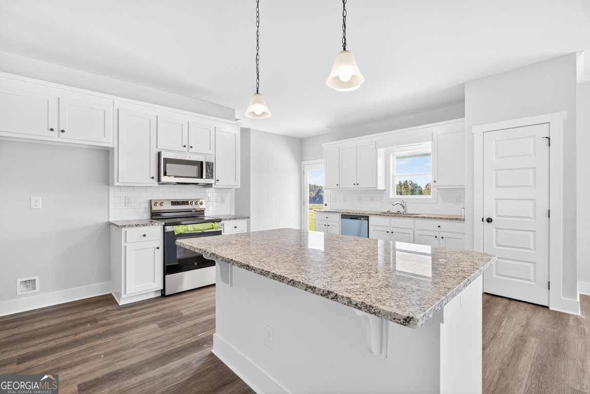 2611 Bethany Bowersville Road, Unit 5 Canon, GA 30520 - Photo 12 of 47 a kitchen with kitchen island granite countertop a sink cabinets and wooden floor