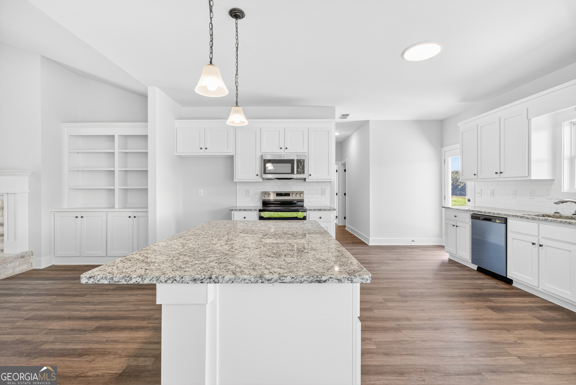 2611 Bethany Bowersville Road, Unit 5 Canon, GA 30520 - Photo 13 of 47 a kitchen with kitchen island granite countertop a stove and a sink with granite countertops