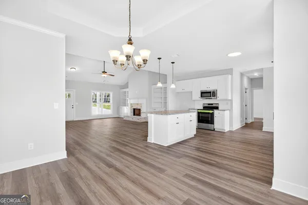 a view of a kitchen with stove and cabinets