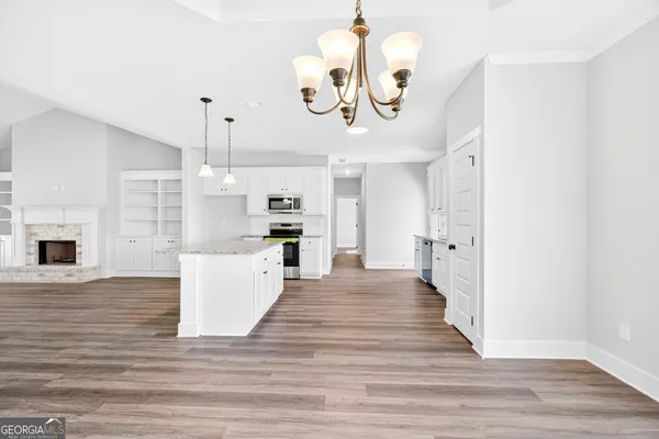 a view of kitchen and living room with wooden floor