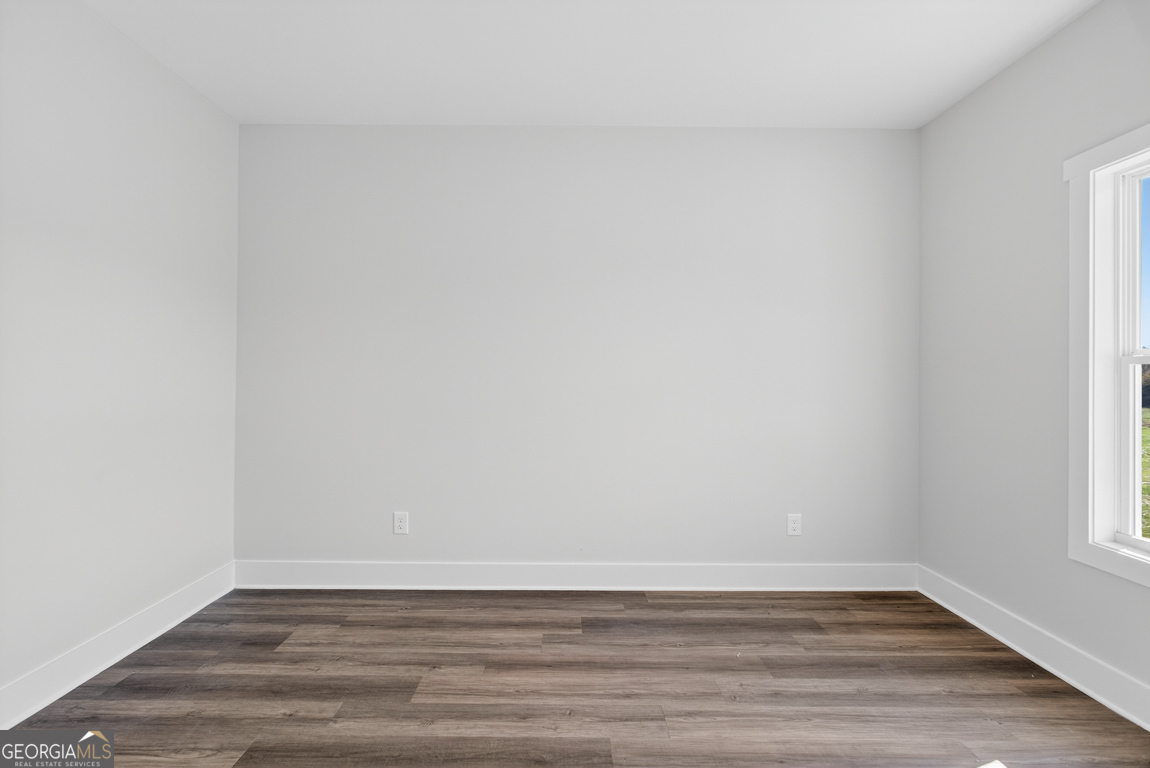 2611 Bethany Bowersville Road, Unit 5 Canon, GA 30520 - Photo 20 of 47 a view of an empty room with wooden floor and a window