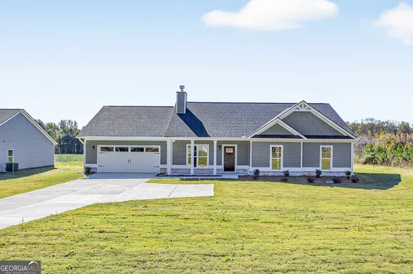 a front view of house with yard and swimming pool