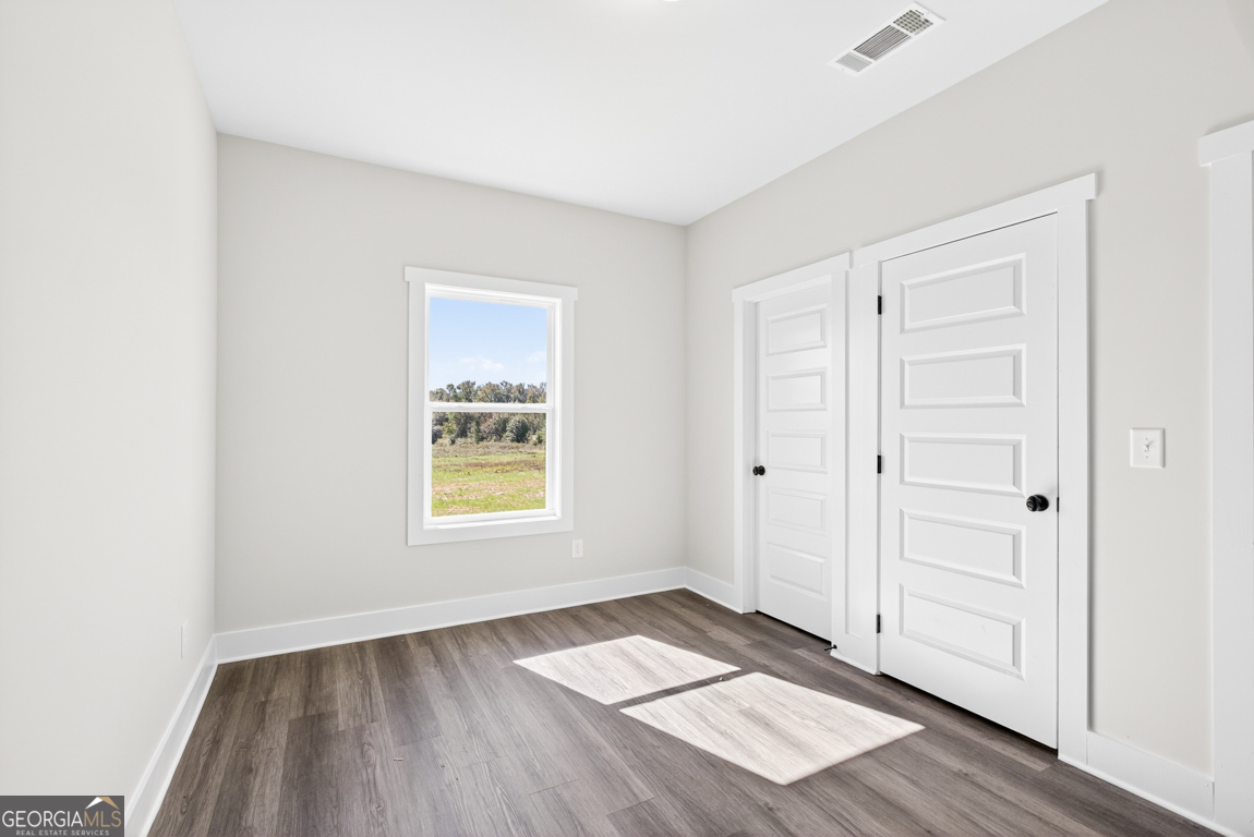 2611 Bethany Bowersville Road, Unit 5 Canon, GA 30520 - Photo 22 of 47 an empty room with wooden floor closet and windows