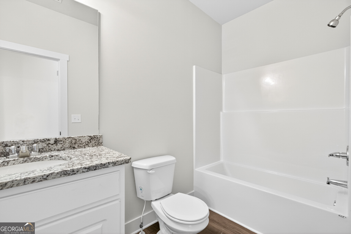 2611 Bethany Bowersville Road, Unit 5 Canon, GA 30520 - Photo 23 of 47 a bathroom with a granite countertop toilet a sink and a bathtub