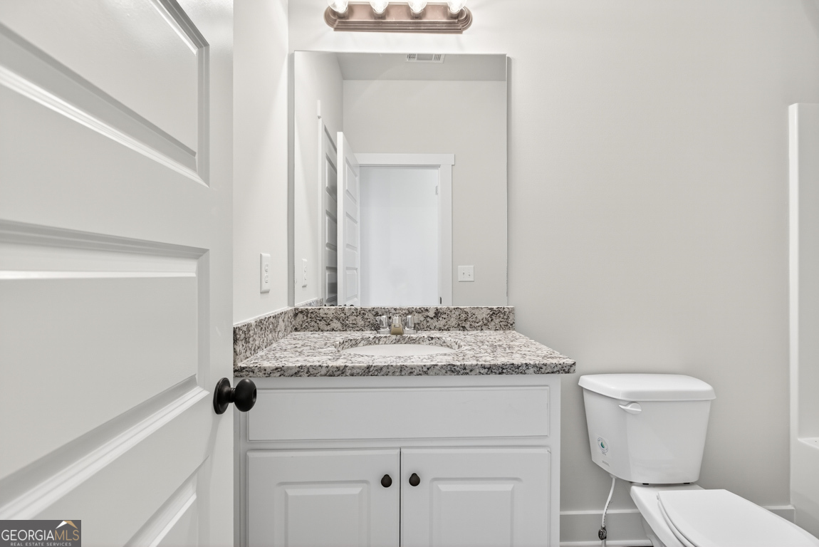 2611 Bethany Bowersville Road, Unit 5 Canon, GA 30520 - Photo 24 of 47 a bathroom with a granite countertop sink toilet and mirror