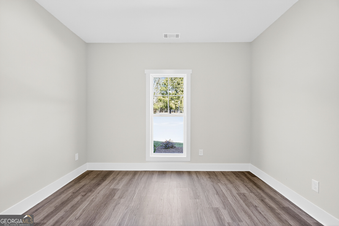 2611 Bethany Bowersville Road, Unit 5 Canon, GA 30520 - Photo 28 of 47 an empty room with wooden floor and window