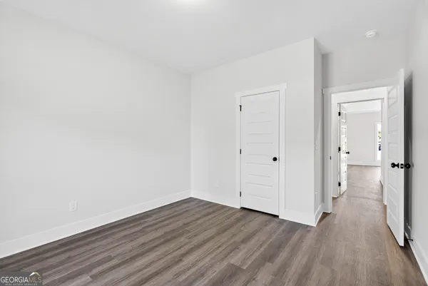 a view of a room with wooden floor