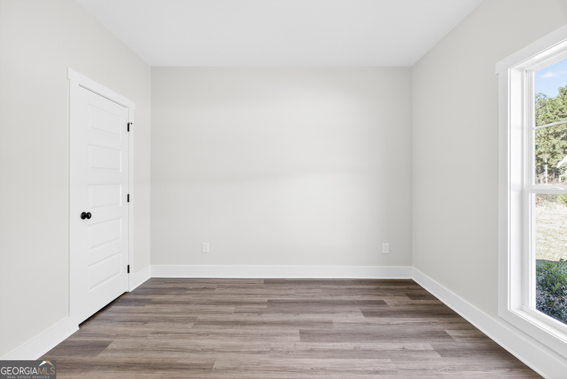 2611 Bethany Bowersville Road, Unit 5 Canon, GA 30520 - Photo 30 of 47 a view of an empty room with wooden floor and a window
