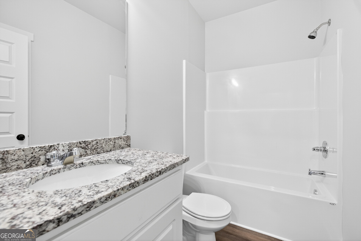 2611 Bethany Bowersville Road, Unit 5 Canon, GA 30520 - Photo 33 of 47 a bathroom with a granite countertop sink a toilet and bathtub