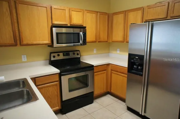 a kitchen with a refrigerator stove and microwave