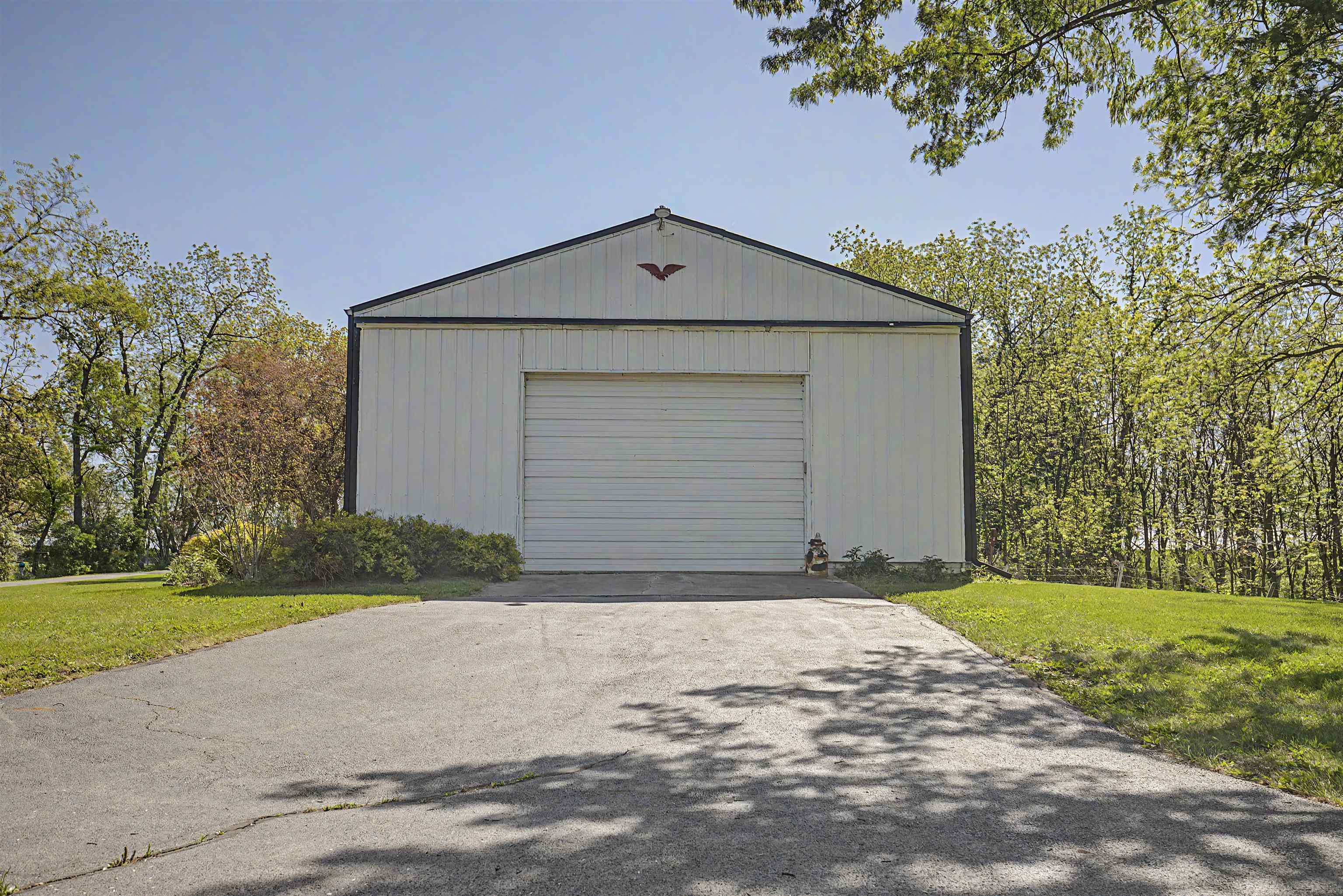 17380 Corbett Road Mount Carroll, IL 61053 - Photo 51 of 65 a front view of a house with a yard and garage